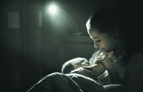 Dream Feed newborn feeding from young mother