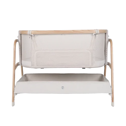 A modern baby bassinet with light wooden legs, white mesh sides, and a spacious storage shelf beneath the crib—perfect for any nursery. Discover its features in our Babybee Pod Bedside Sleeper review. Minimal yet contemporary design at its best.