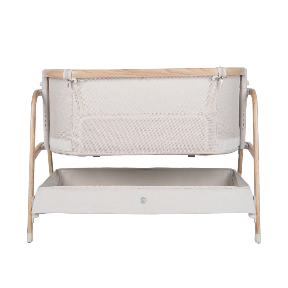 A modern baby bassinet with light wooden legs, white mesh sides, and a spacious storage shelf beneath the crib—perfect for any nursery. Discover its features in our Babybee Pod Bedside Sleeper review. Minimal yet contemporary design at its best.