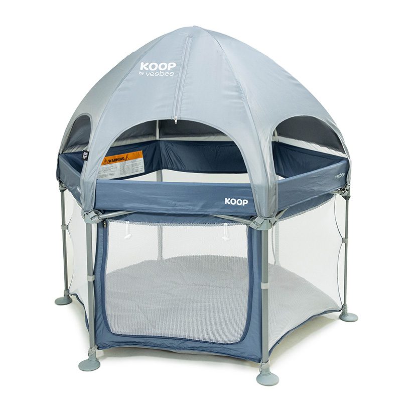 A gray KOOP Play Yard with a dome-shaped canopy, mesh sides, and soft floor features the KOOP by veebee label—designed for safely containing infants or toddlers. Perfect for parents seeking a trusted option after reading a KOOP Play Yard review.