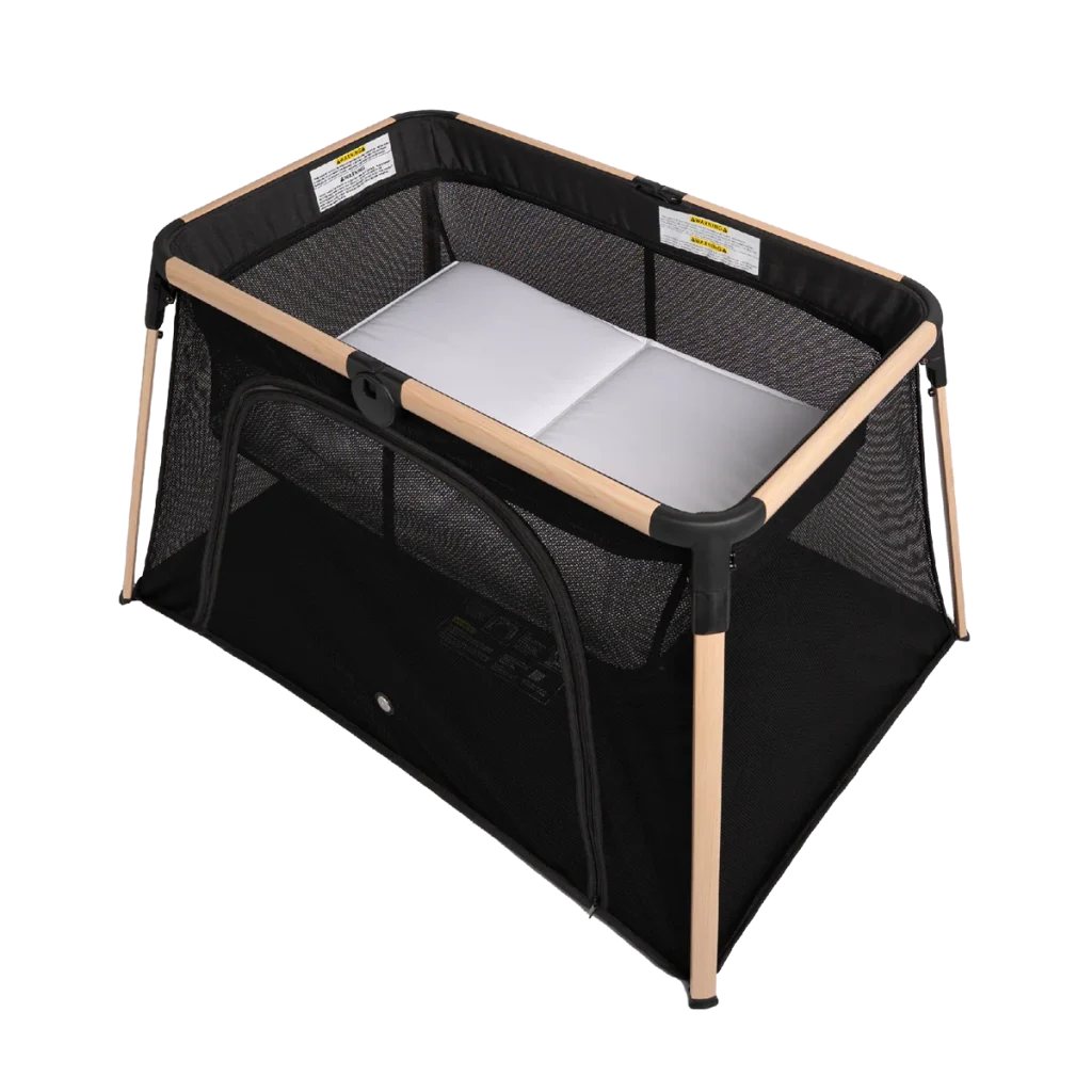 A portable baby crib with a black mesh frame, light wooden supports, a white mattress, and a zippered side opening is featured on a white background—perfect for those searching for an honest Babybee ARLO Portacot review.